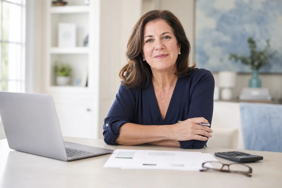 Home care agency owner reviewing this month's marketing budget at her desk