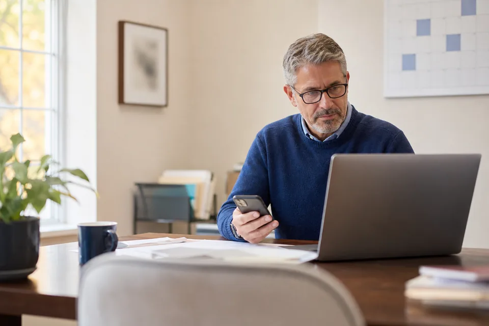 Enrolled agent reviewing his filing season campaign on a laptop in a quiet tax office